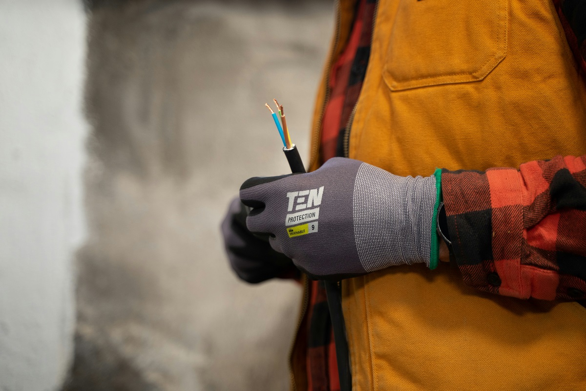 electrician wearing gloves holding a wire